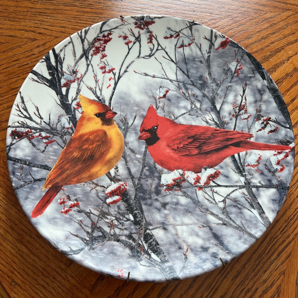 Ceramic plate featuring two winter cardinals